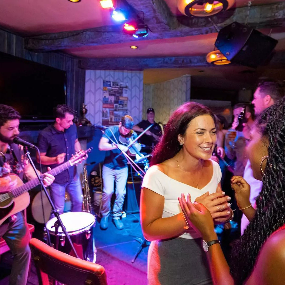 Live band playing while people dance to the music.